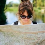 girl-with-sunglasses-holding-tourist-map