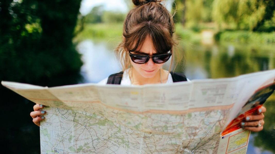 girl-with-sunglasses-holding-tourist-map